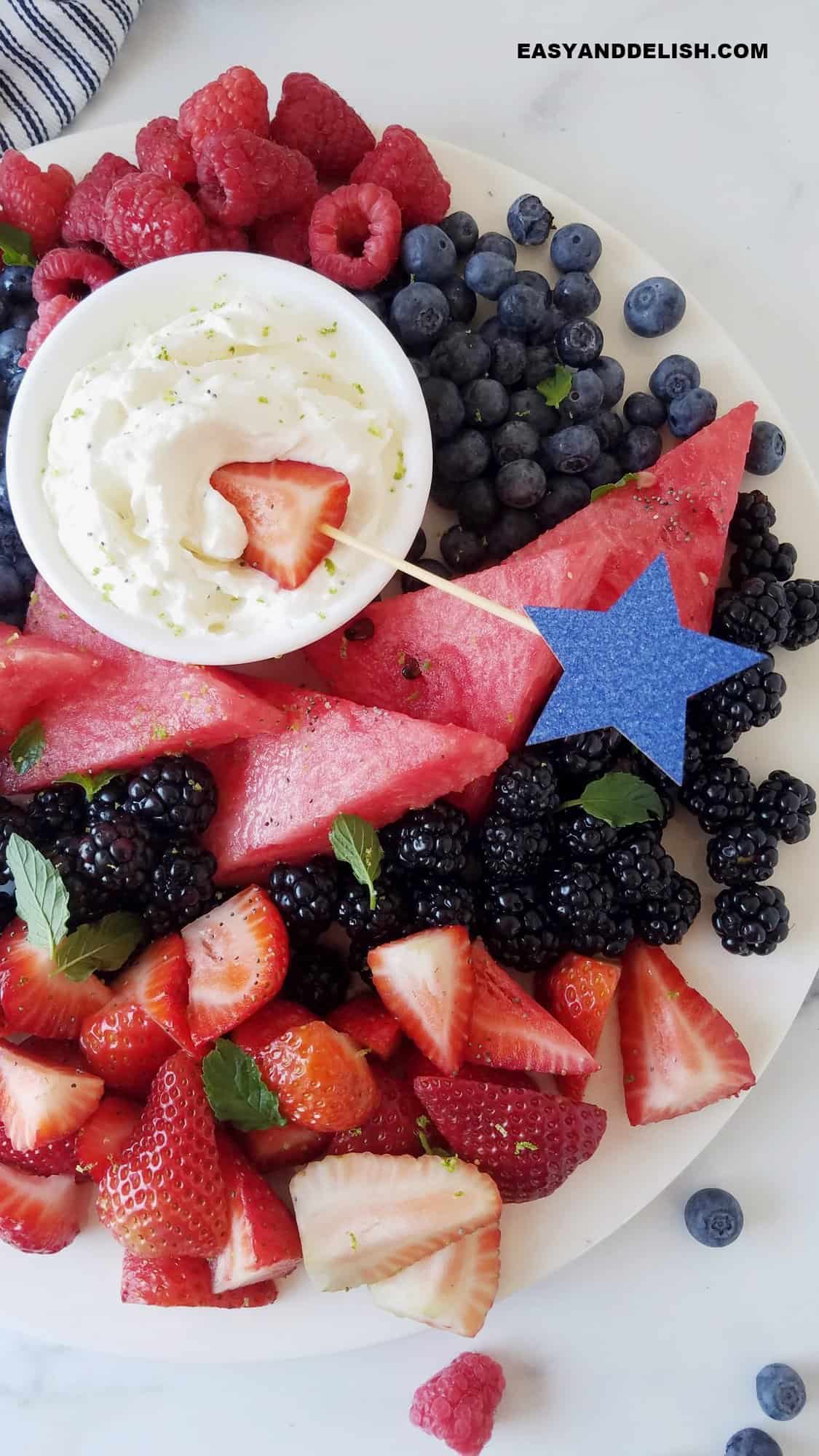 half platter of keto fruit dip and berries decorated for the fourth of july