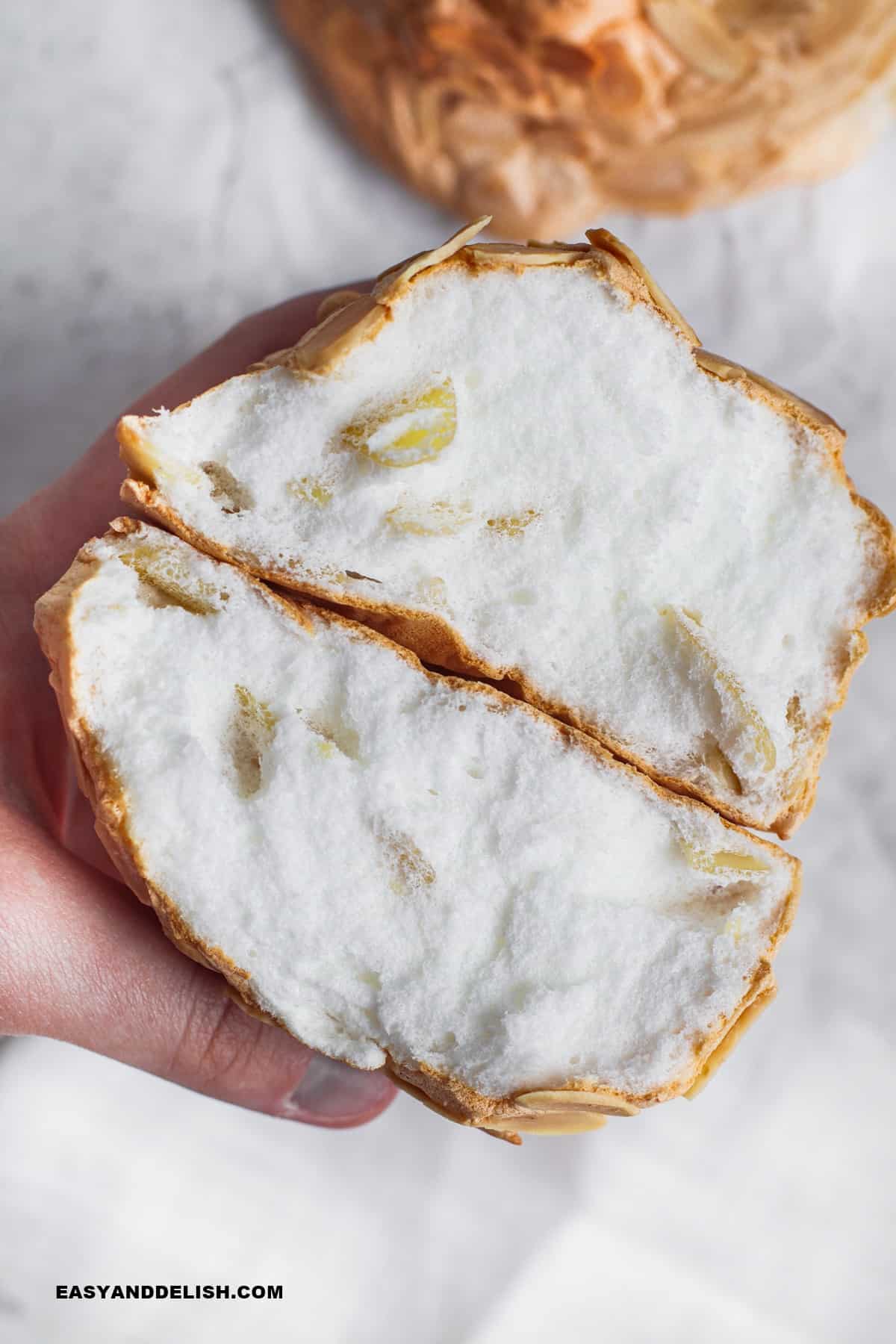 keto cloud bread cut in half and held in the hands