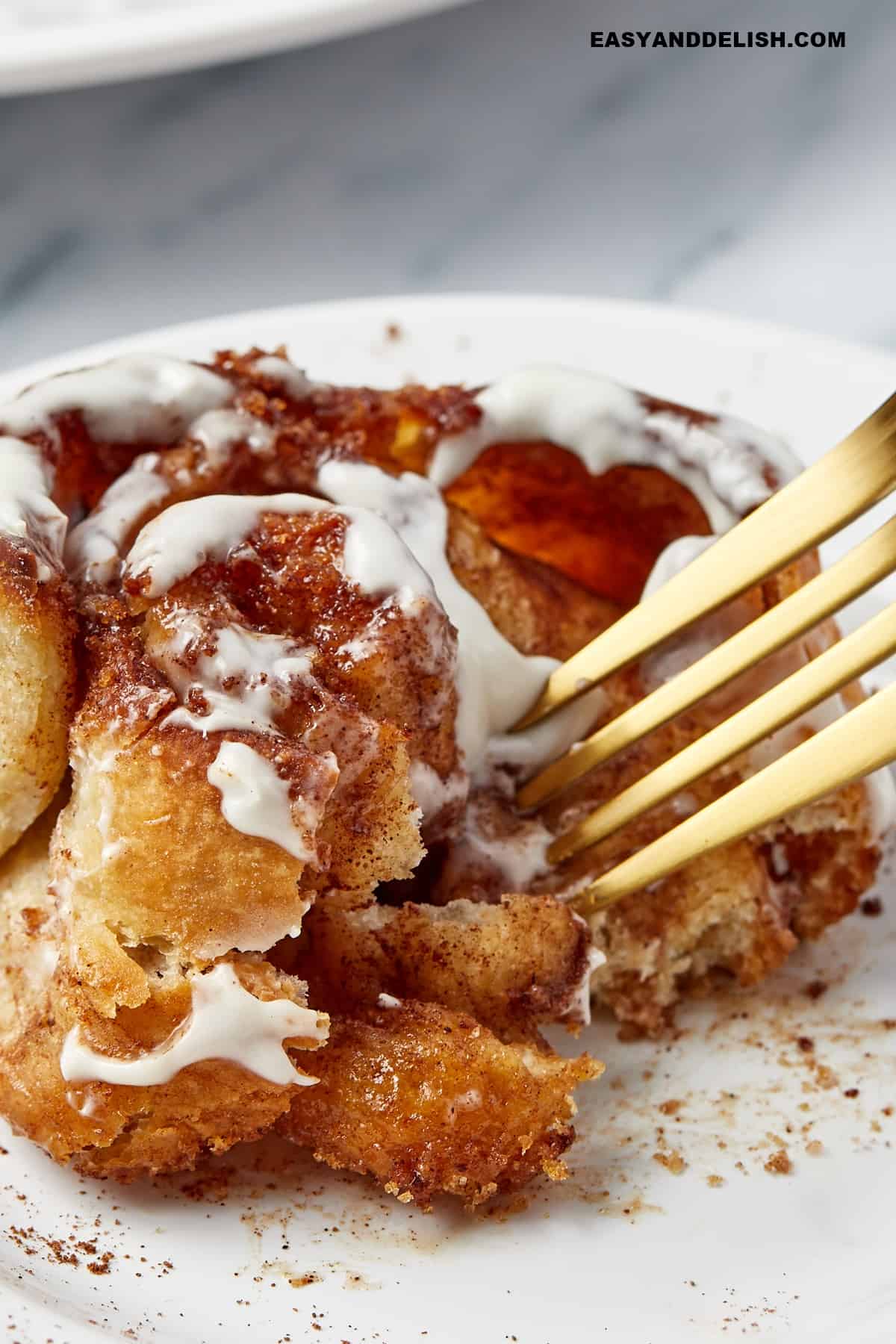 Roll partially eaten with a fork on top.