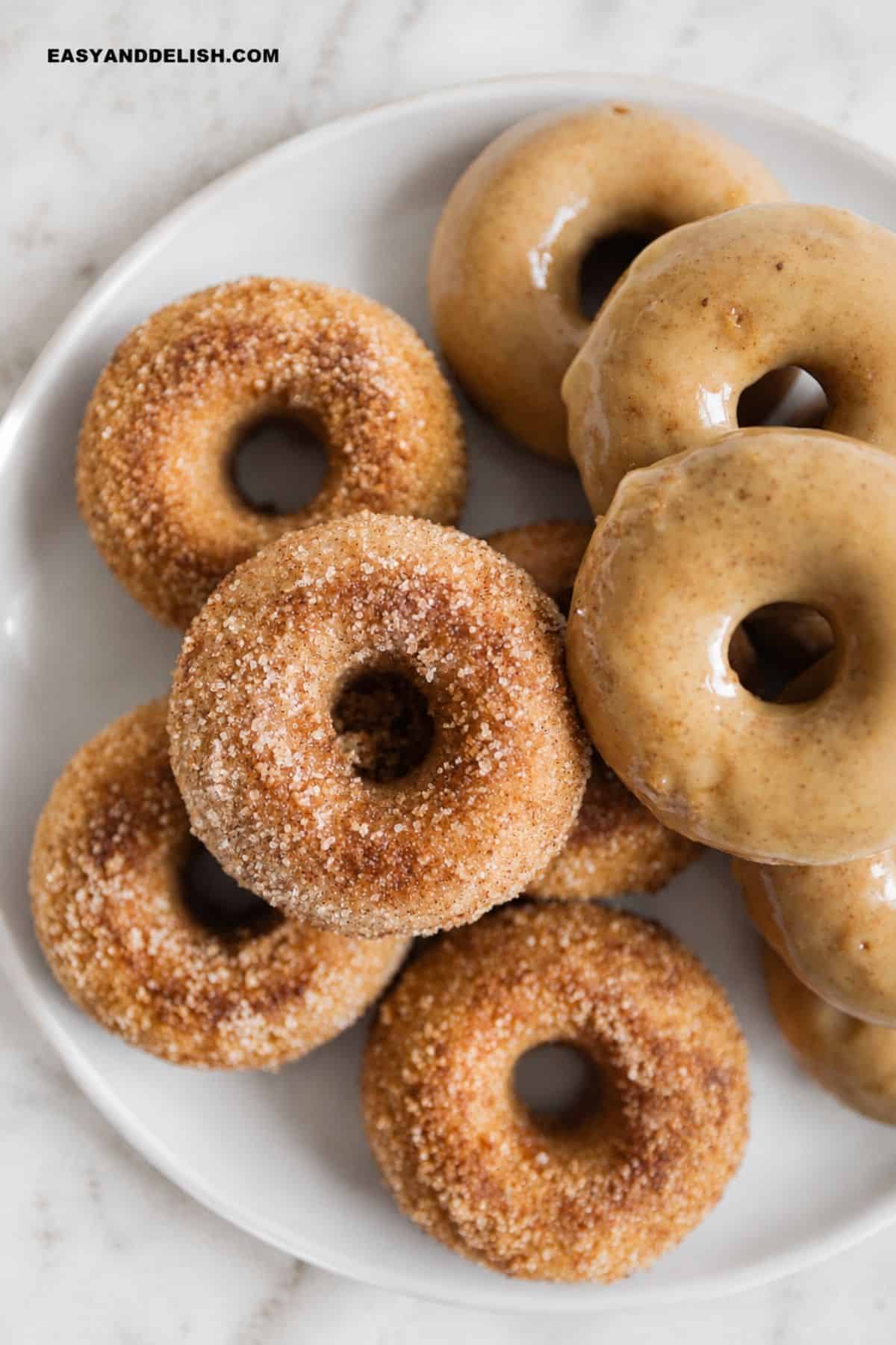 Apple cider donuts topped with maple glaze and cinnamon sugar.