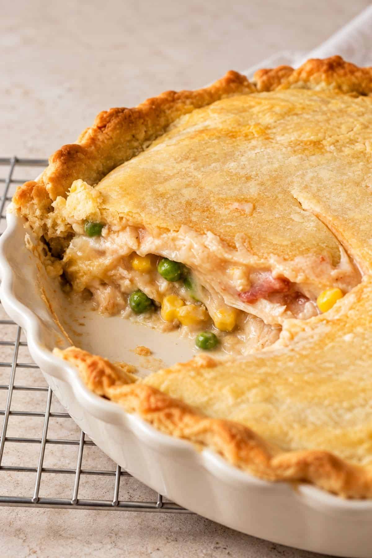 Homemade Chicken Pot Pie with a golden, buttery top crust and crimped edges in a ceramic pie dish.