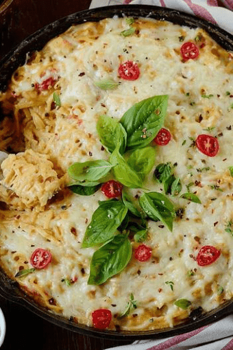 Casserole garnished with tomatoes and basil on top