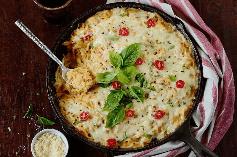 Casserole garnished with tomatoes and basil on top