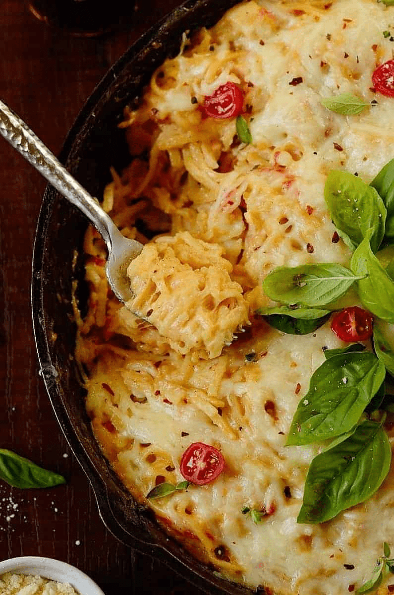 half of the casserole witha  fork on the side and garnishes on top