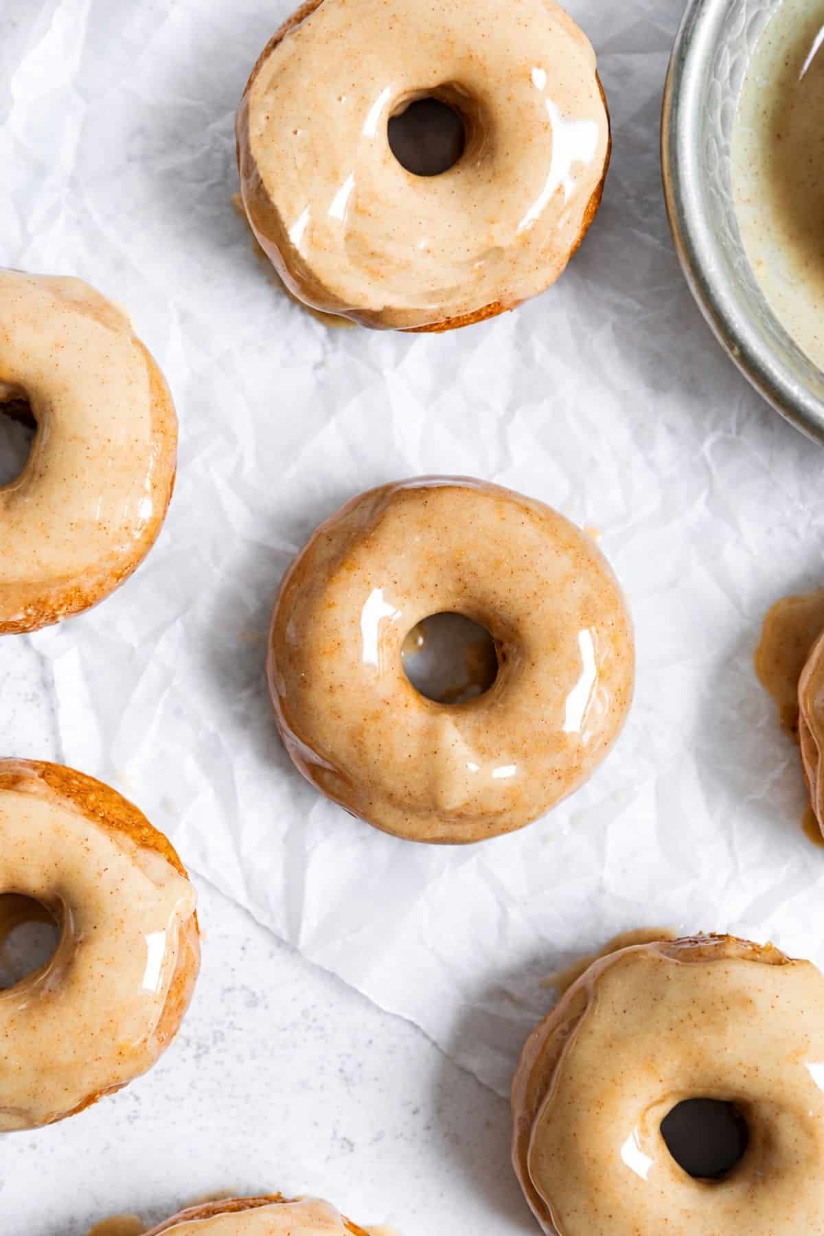 Mini baked donuts topped with glossy maple cinnamon glaze.