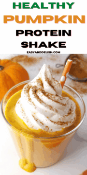 a close up of a galss of pumpkin pie protein shake on a table.