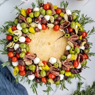 keto antpasto salad on a charcuterie baord with some Mediterranean vegetables on the side.i