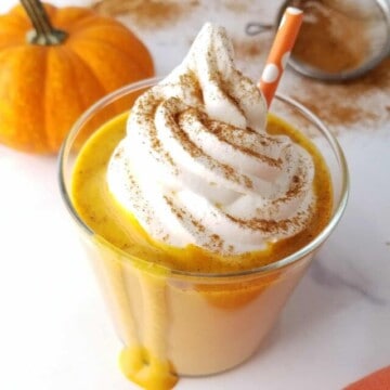 a glass of pumpkin pie proten shake dripping from top to bottom.