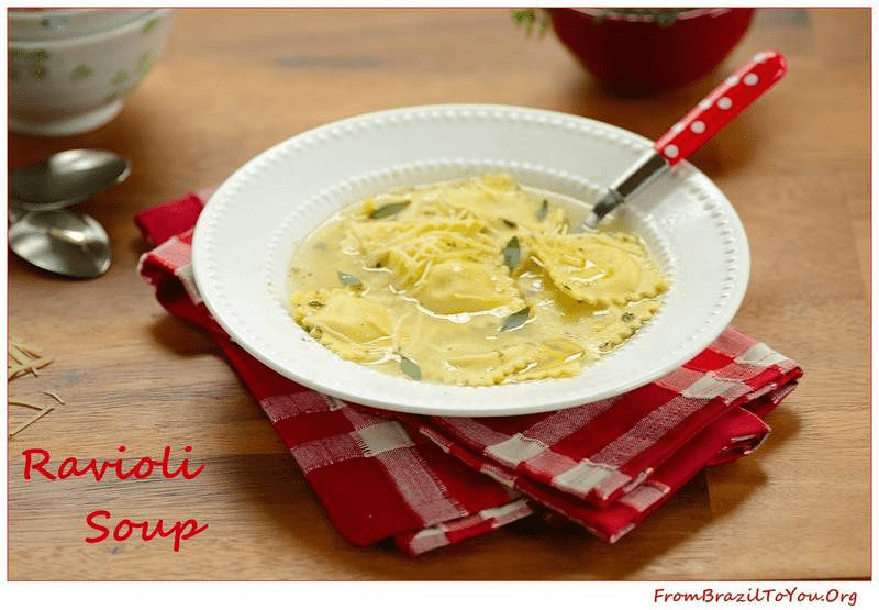a plate of ravioli soup with herbs on top