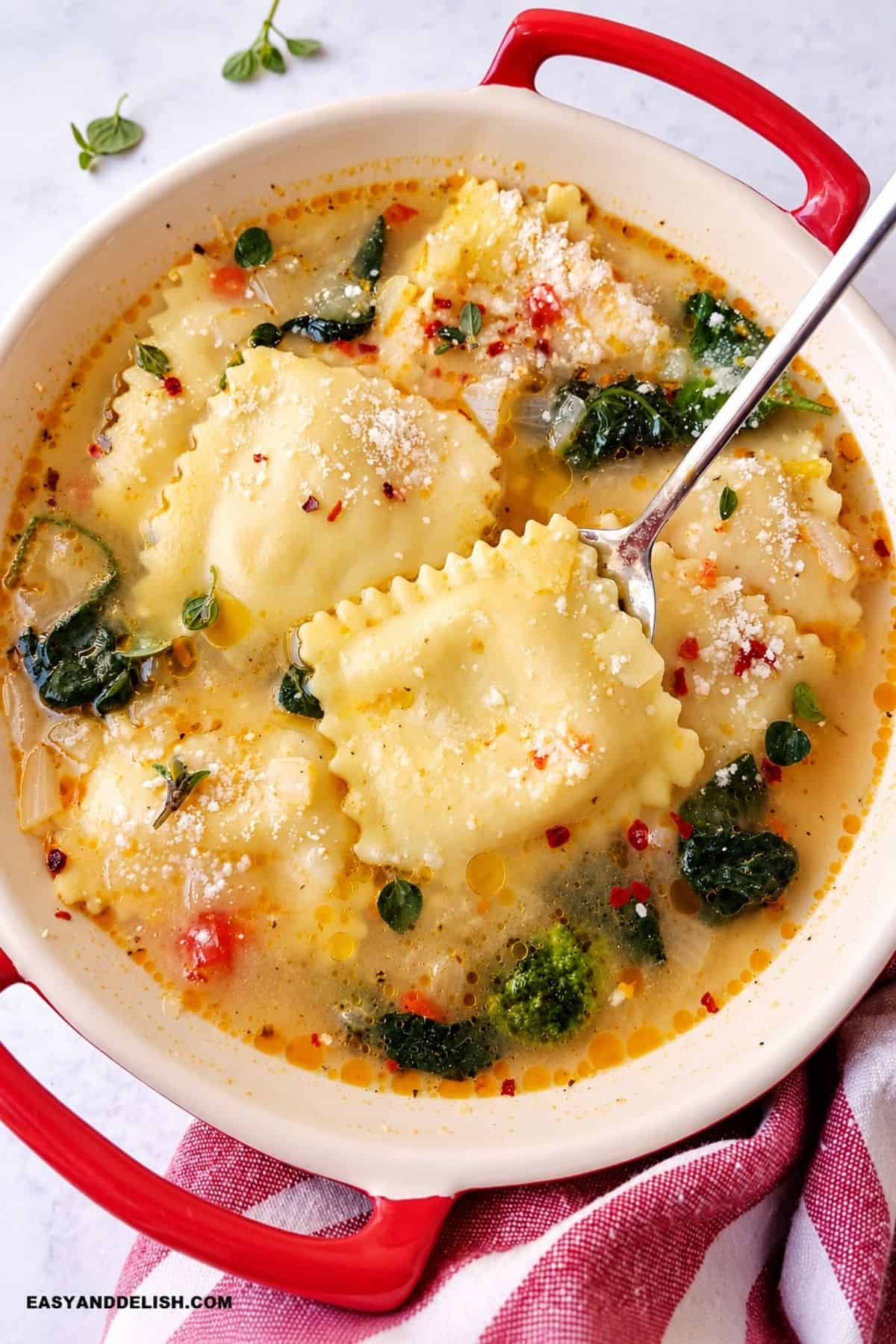 Ravioli Soup with spinach, Parmesan, herbs, and red pepper flakes.