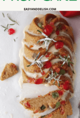 CLOSE UP PIN OF GLUTEN-FREE FRUIT CAKE WITH GARNISHES ON THE SIDES.