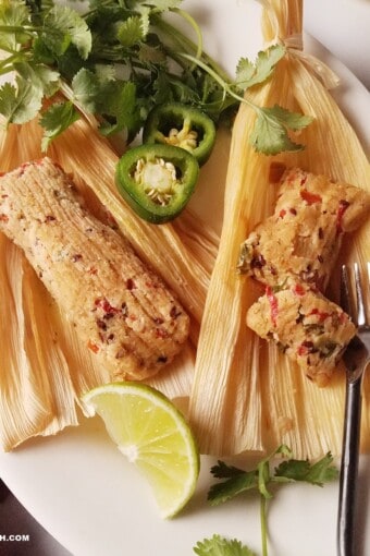 keto tamales for Christmas on a platter with jalapenos, cilatro, and lime wedges on the sside.