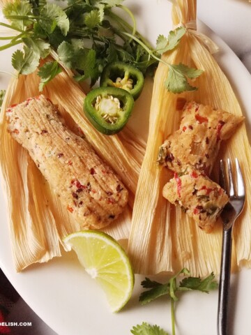 keto tamales for Christmas on a platter with jalapenos, cilatro, and lime wedges on the sside.