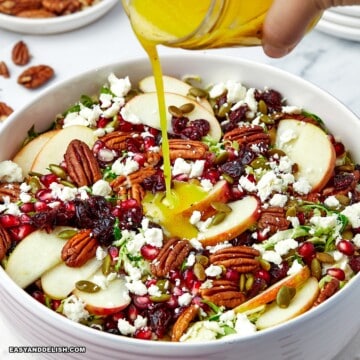 close up of shaved brussels sprout salad dressed with citrus salad dressing .