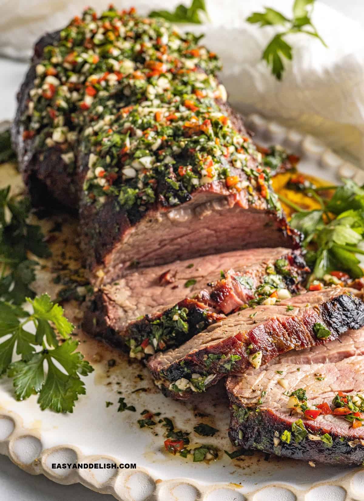 sliced roast with chimichurri sauce.