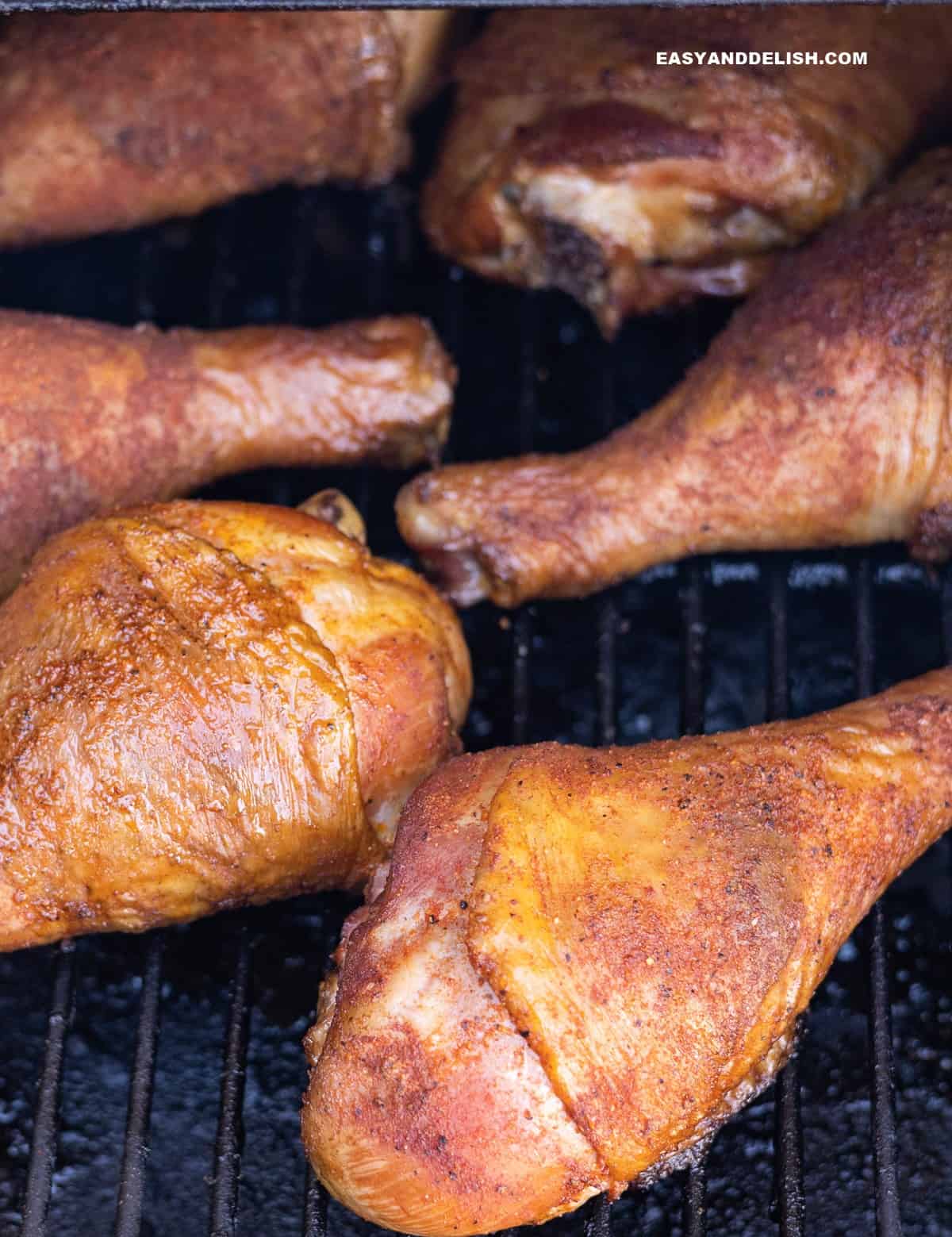 turkey legs in coooking in a smoker for a barbecue party.