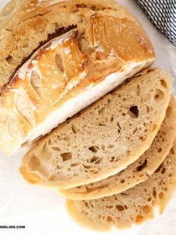 partially sliced easy sourdough bread on a table.