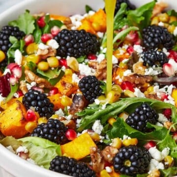 Roasted Butternut squash salad with kale drizzled with apple cider vinaigrette.o