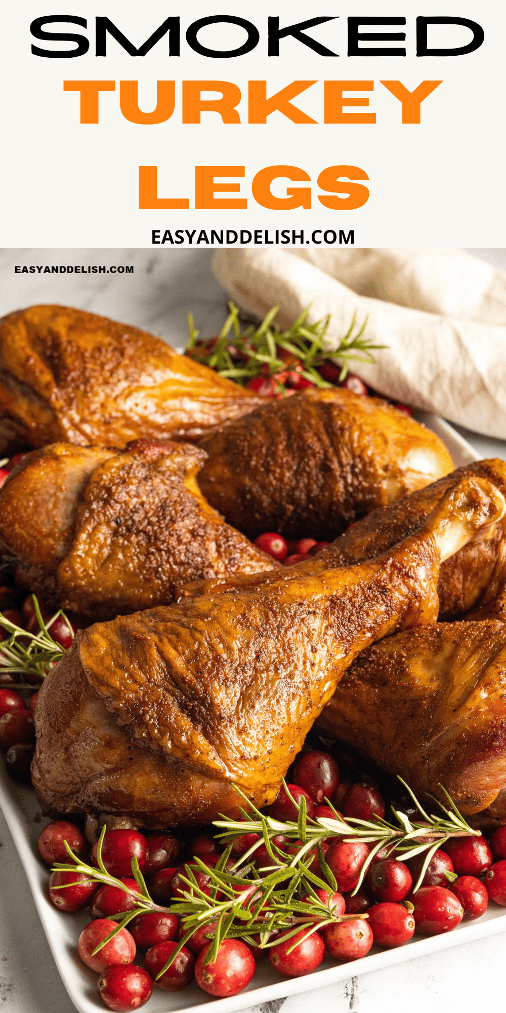pin of close up smoked turkey legs with herb and cranberries.