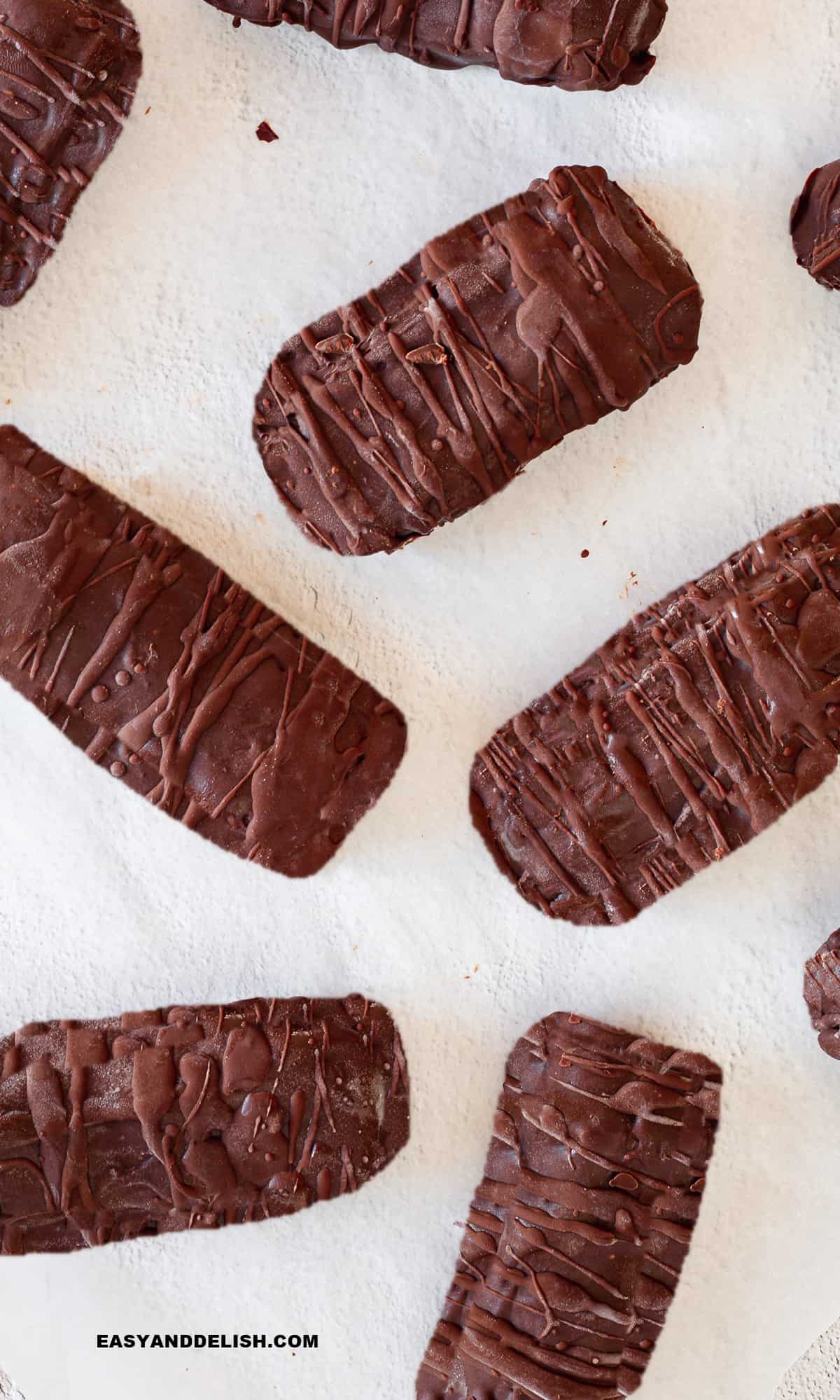 Several homemade low-carb protein bars over a table.