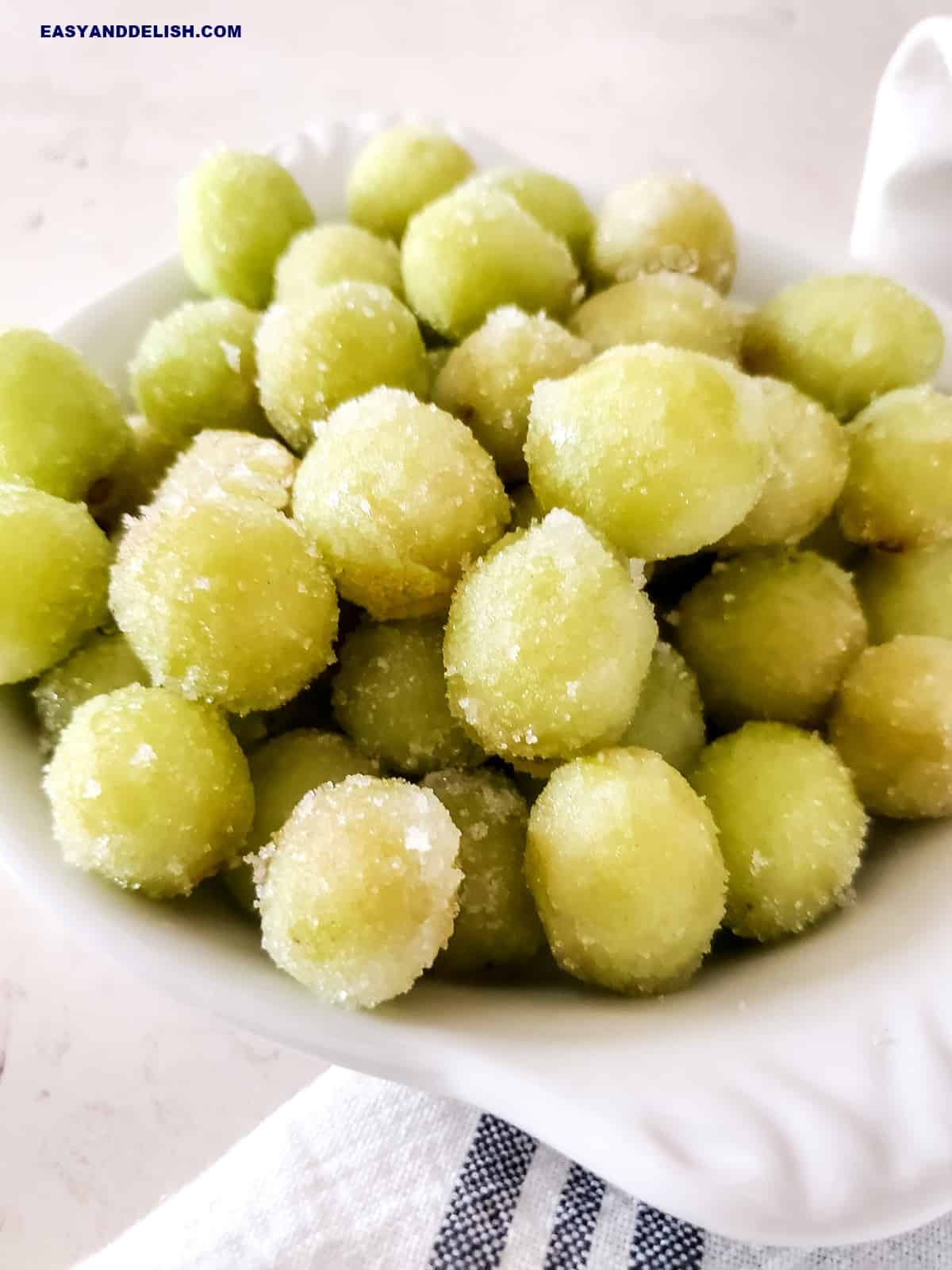 close up of suagred prosecco grapes witha  napkin under the bowl.