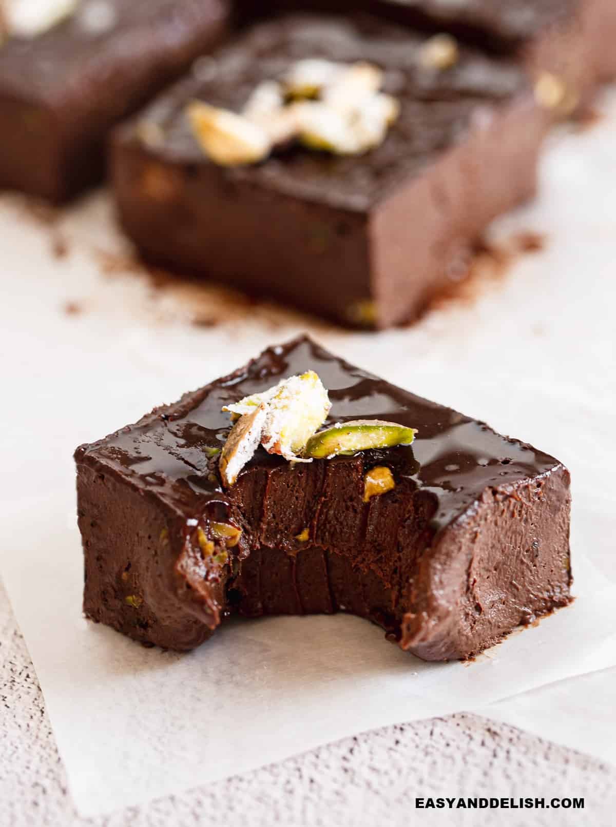 a square of a no bake brownie bitten in the center.