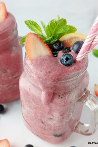 close up of a glass containing dripping anti-inflammatory smoothie made with berries.