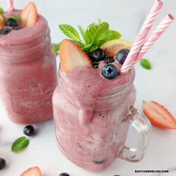 close up of a glass containing dripping anti-inflammatory smoothie made with berries.
