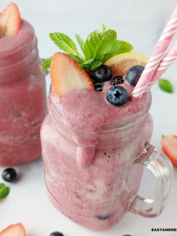 close up of a glass containing dripping anti-inflammatory smoothie made with berries.