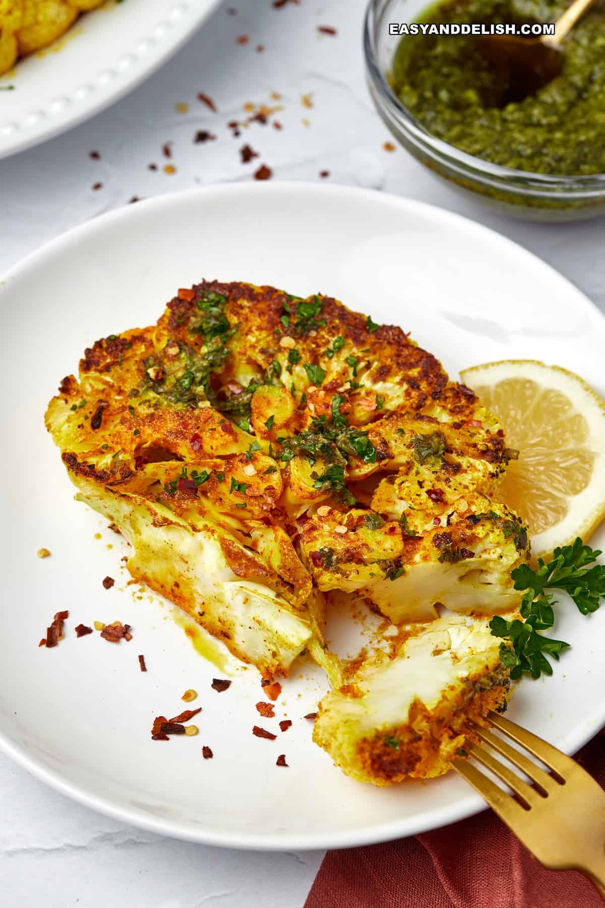 one cauliflower steak cut iin a fork.