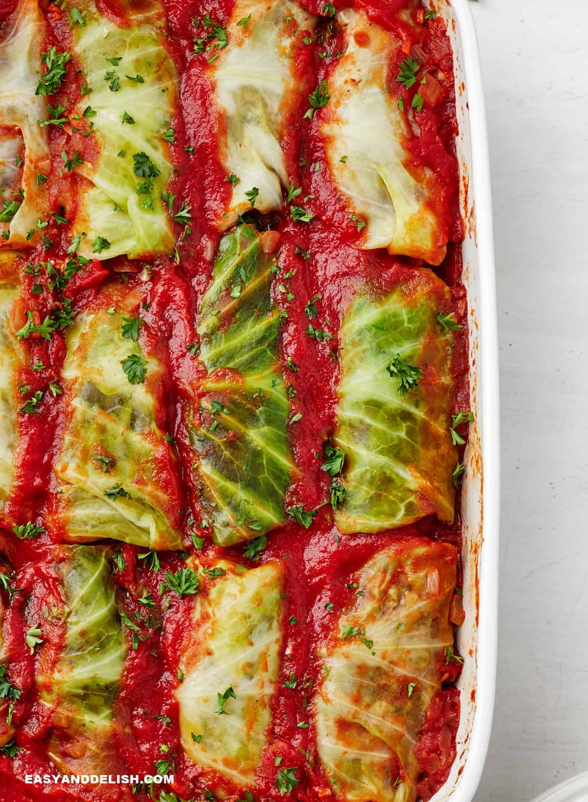 a side close up of Keto cabbage rolls in a baking dish. 