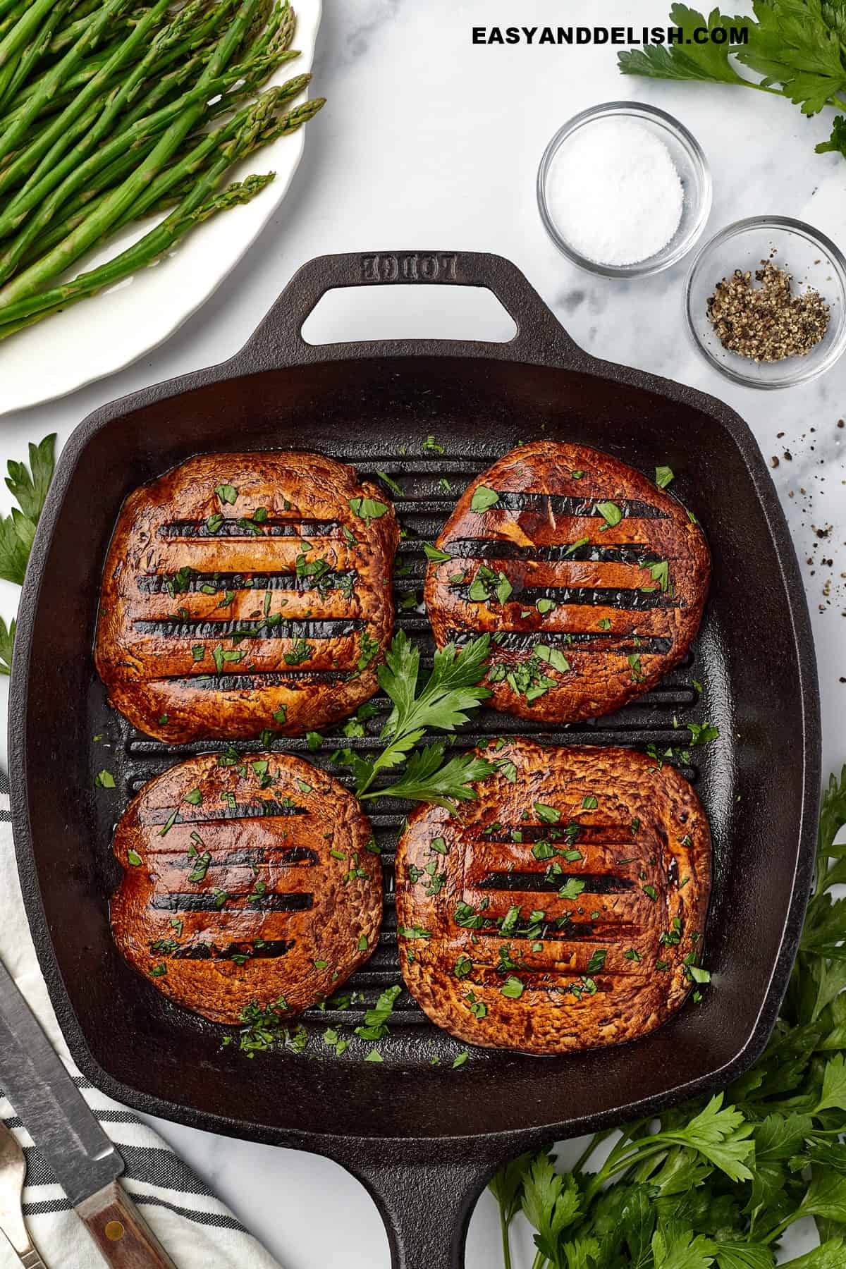 portobello mushroom steaks ina grill pan with ehrbs.