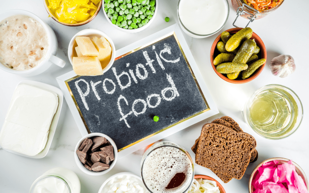 a sign with the word probiotic food and realted foods around it.