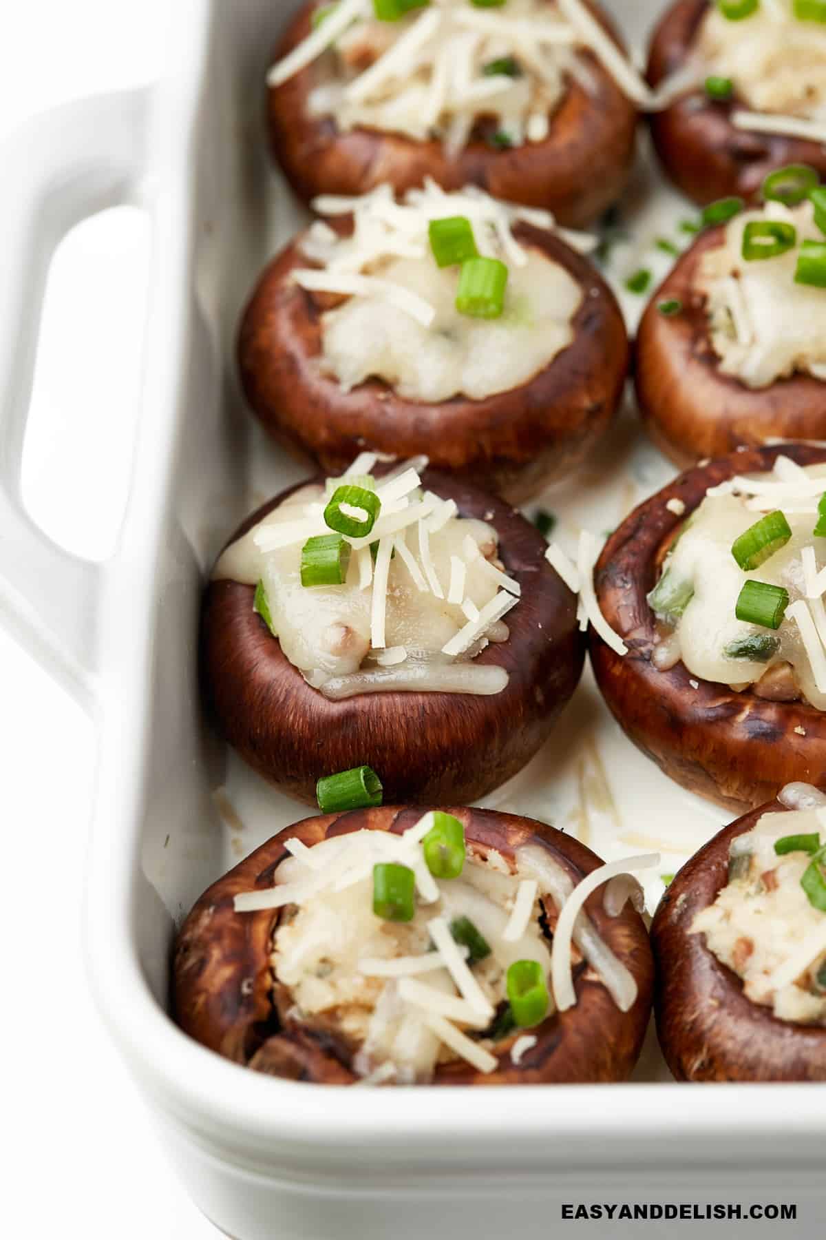 a baking dish full of cheese-stuffed mushrooms.