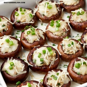 copycat Cheesecake Factory stuffed mushrooms garnished with chopped green onions on top.