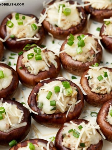 copycat Cheesecake Factory stuffed mushrooms garnished with chopped green onions on top.