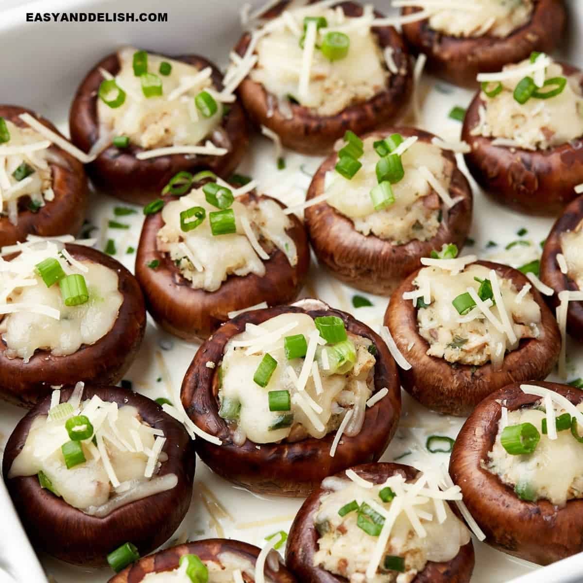 copycat Cheesecake Factory stuffed mushrooms garnished with chopped green onions on top.