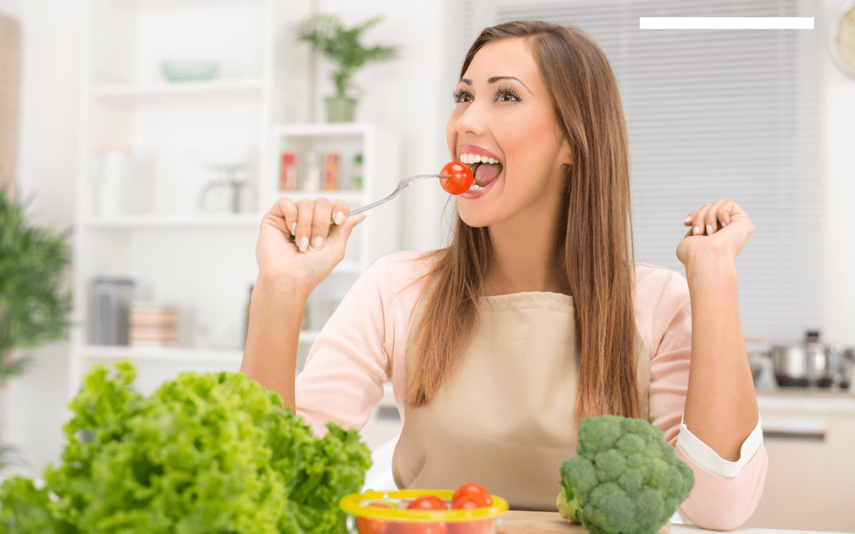 A woman eating healthy stuff with a fork.