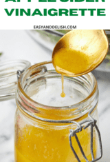 close up of a poon and jar of apple cider vinaigrette.