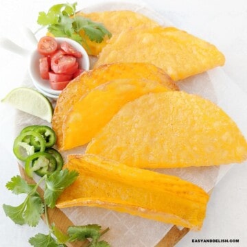 a platter with several crispy keto cheese tacos shells.