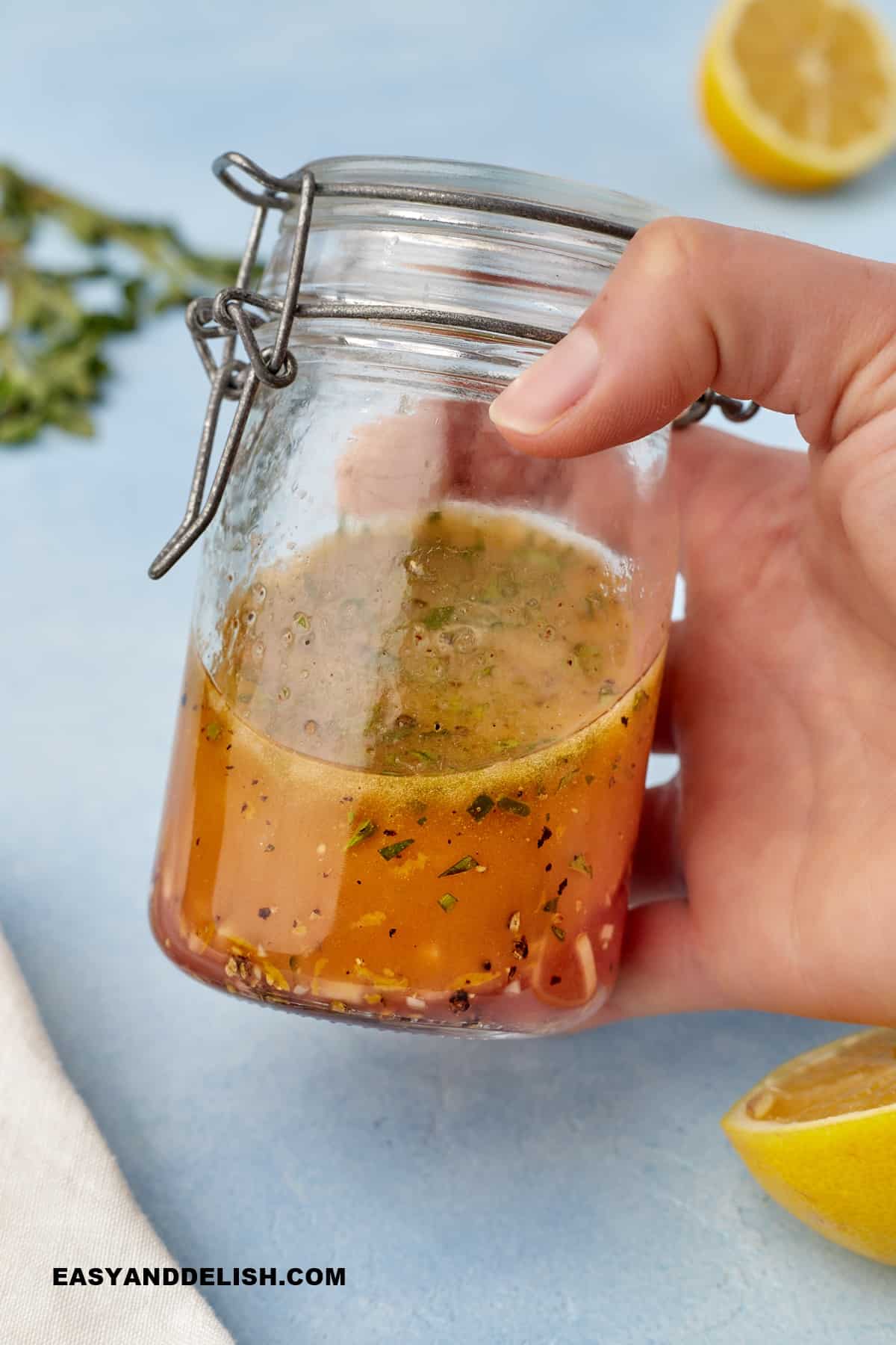 a hand shaking a mason jar. 