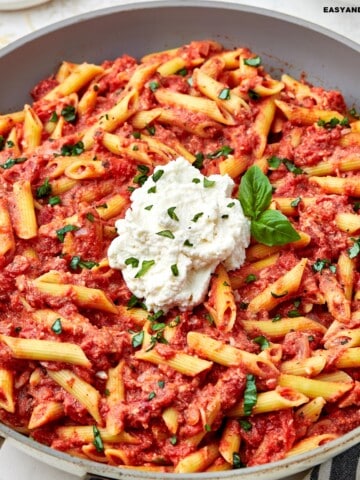 close up image showing a skillet full of copycat Cheesecake Factory four cheese pasta.