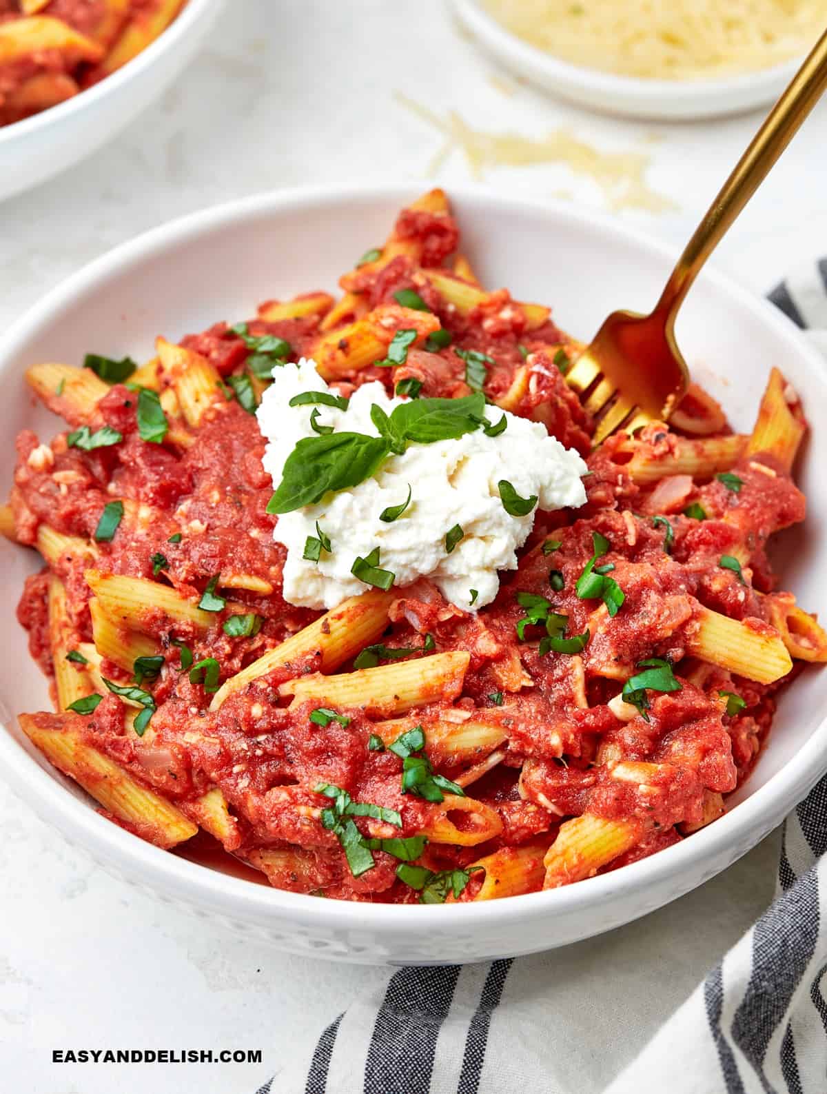 a bowl with four cheese pasta and garnishes on top. 