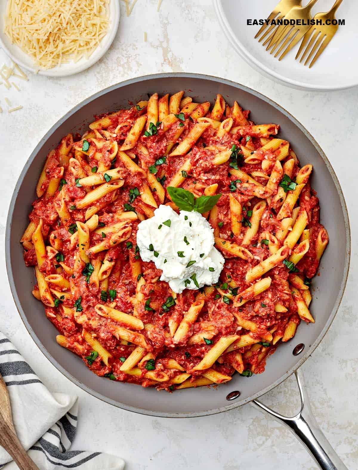 a skillet with resturant-quality dinner dish  with some garnishes around.