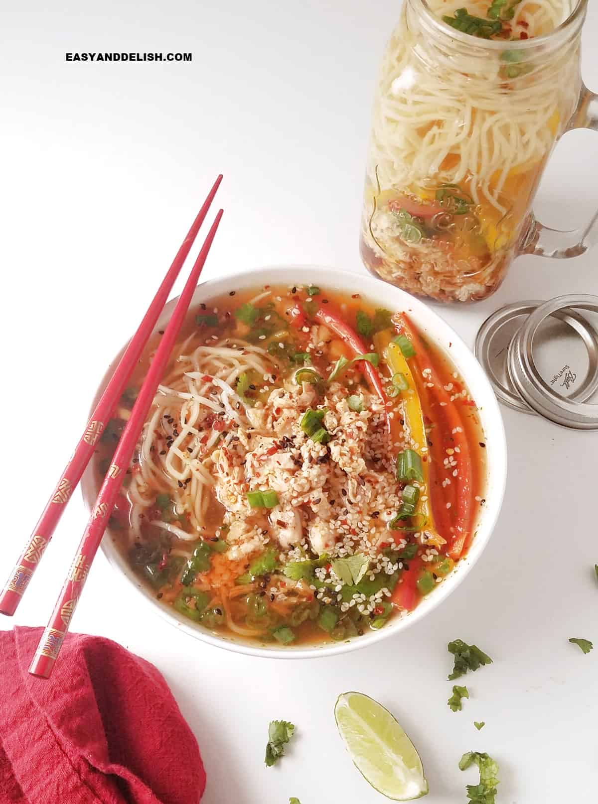 a jar and also a bowl of low-carb, gluten-free chicken noodle soup with chopsticks and some garnishes around. 