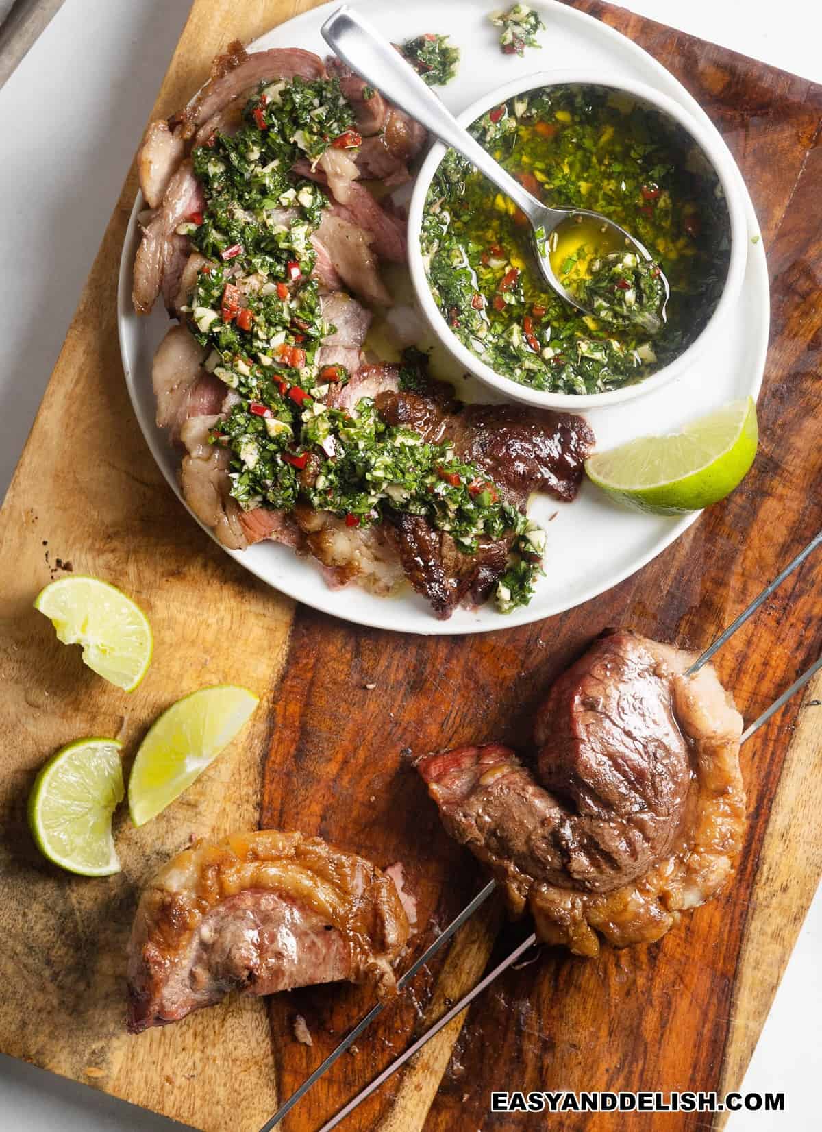 whole and sliced grilled picanha steak topped with chimichurri sauce.