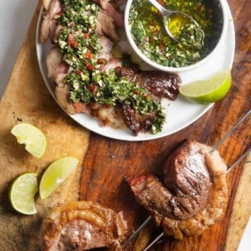whole and sliced grilled picanha steak topped with chimichurri sauce.