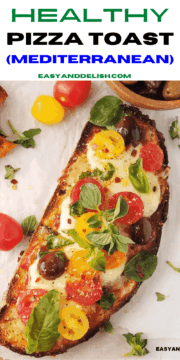 a close up of a bread pizza on a table with some of its ingredients around it.