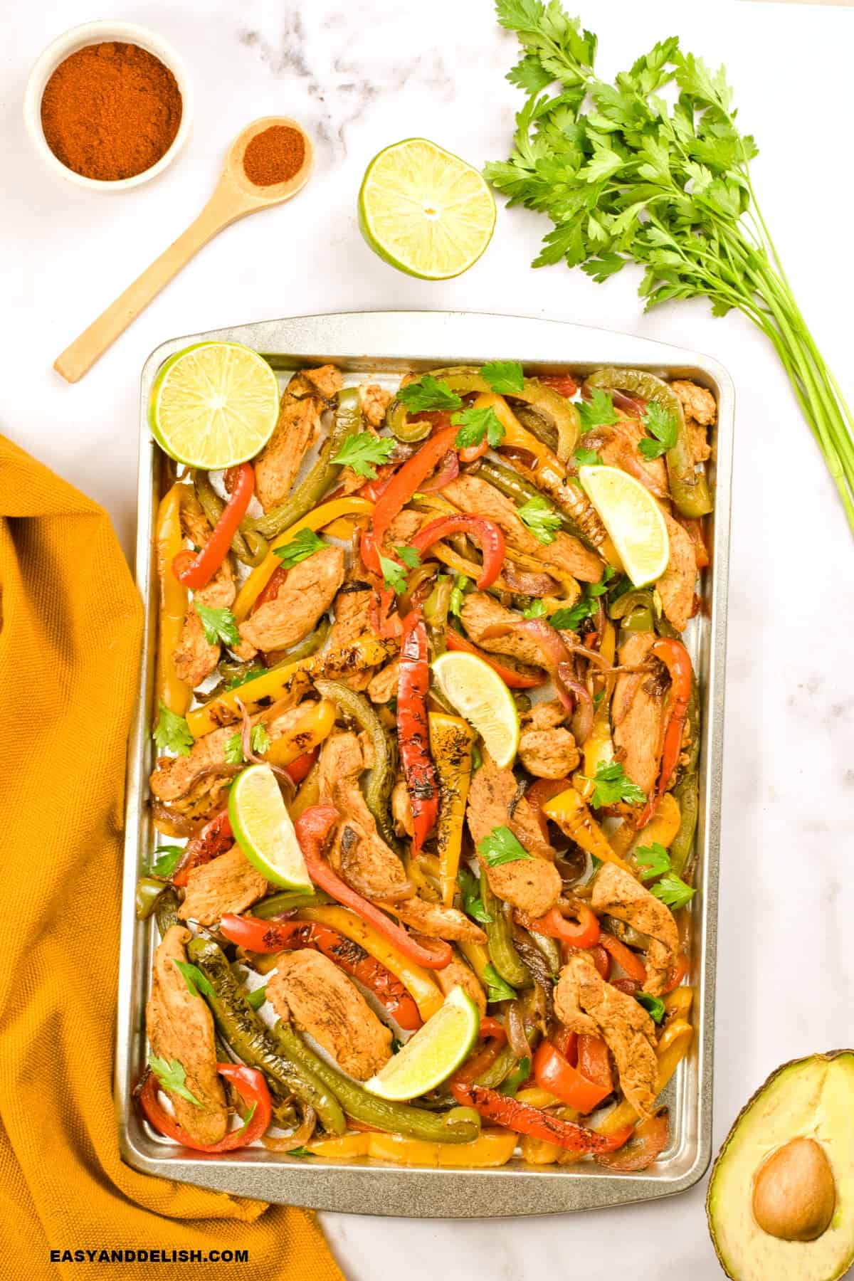 sheet pan keto fajitas with a napkin and ingredients around it.