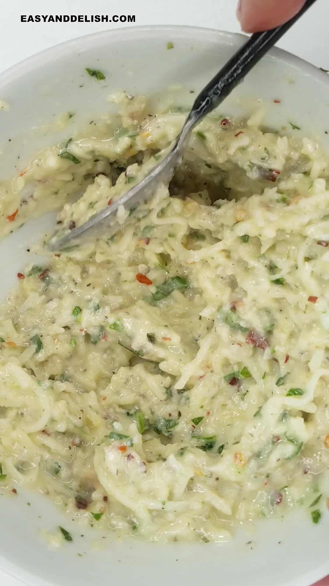 garlic bread spread mixed with a spoon.